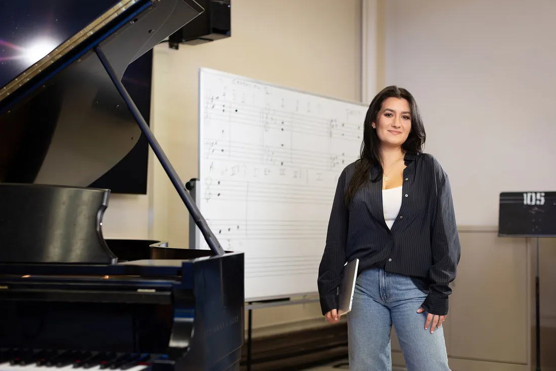 Senses student Music Industry Student and Entrepreneur, Ania Kapllani, pictured in Crouse college.playing piano.